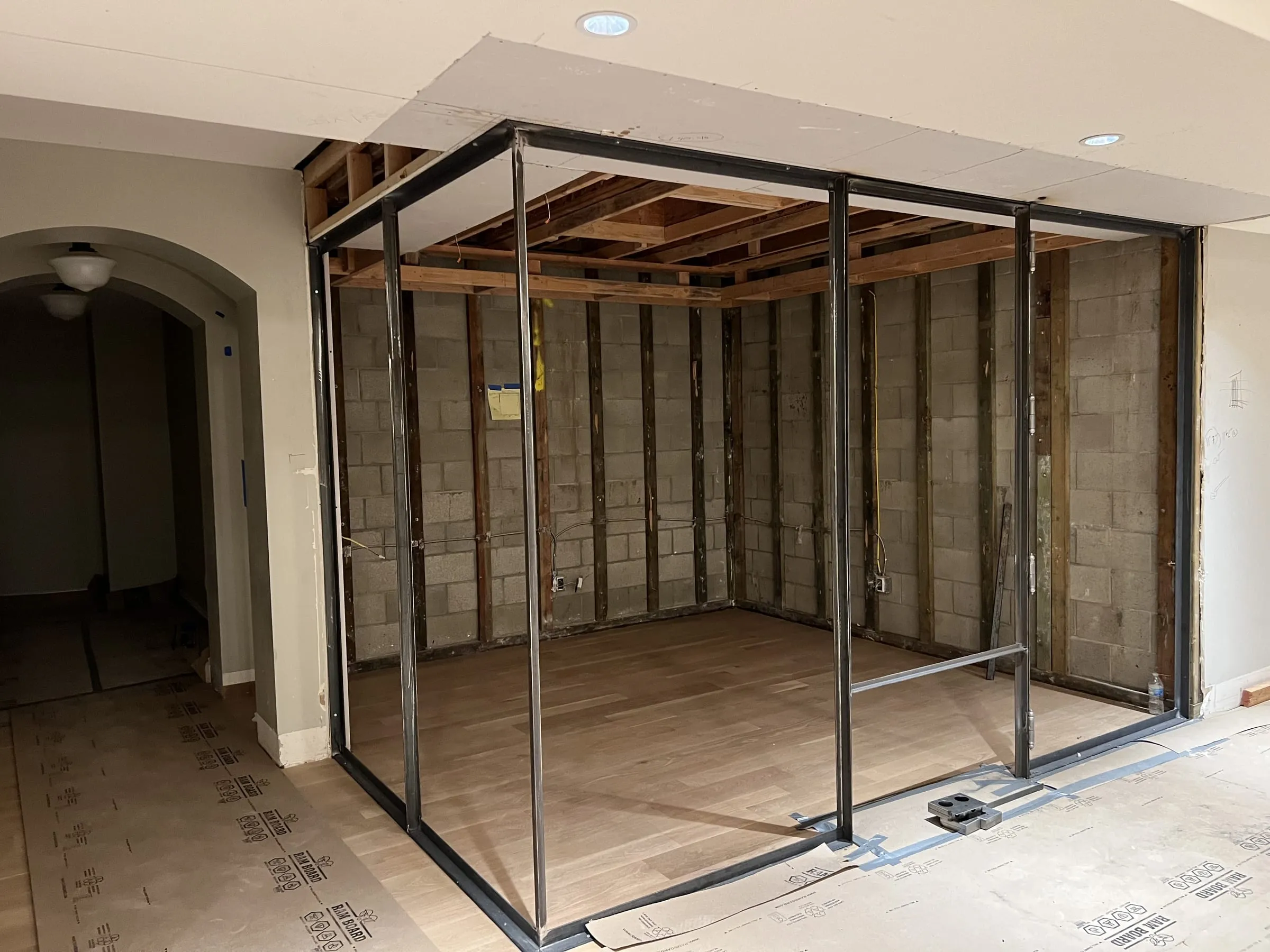 Black metal frame of the wine room before the glass was installed